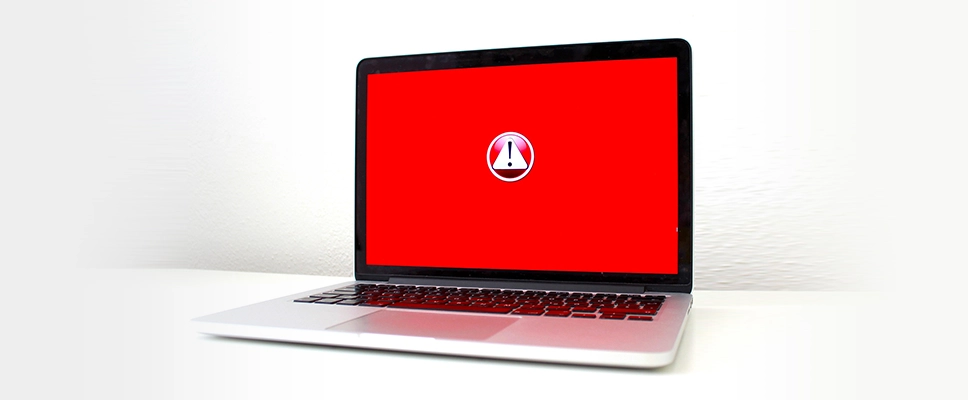 WordPress Troubleshooting image_Laptop with a red background and an alert symbol in the center of the screen