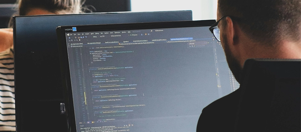 WordPress Security Services image_man in black shirt sitting beside black flat screen computer monitor